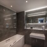 A bathroom with a shower connected to a bath tub.