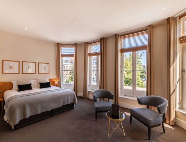 The Resident Kensington Deluxe Bedroom with bay windows across Kensington.