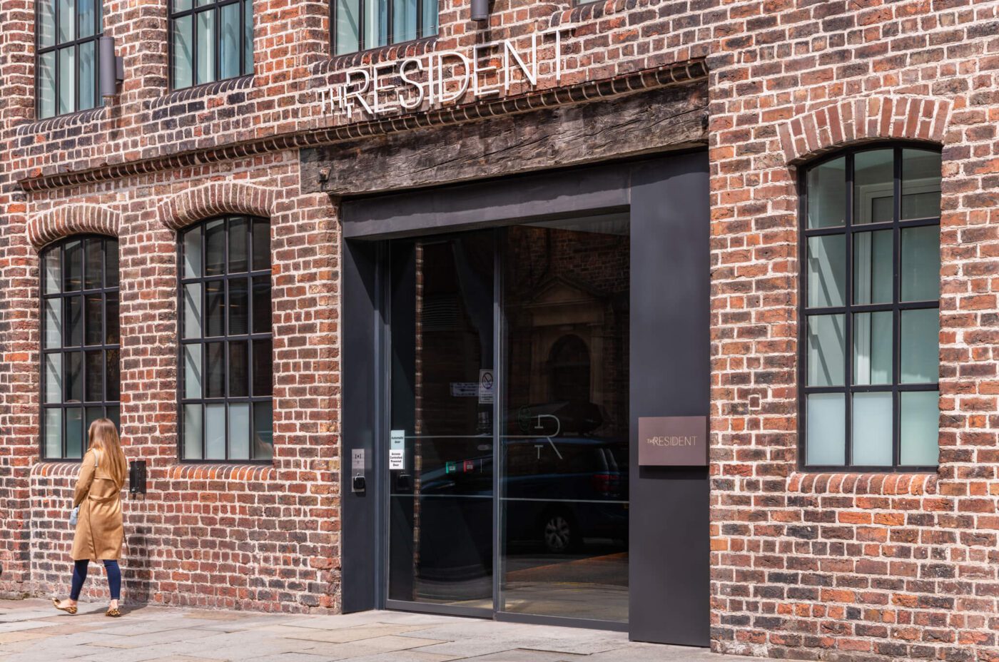 A guest leaving The Resident Liverpool, showcasing the exterior and Ropewalks Location