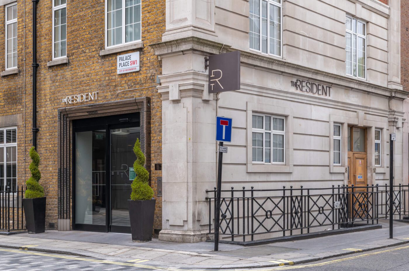 A street corner features a building with signs that read 