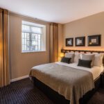 A suite with a double bed and bedside tables, located in Victoria.